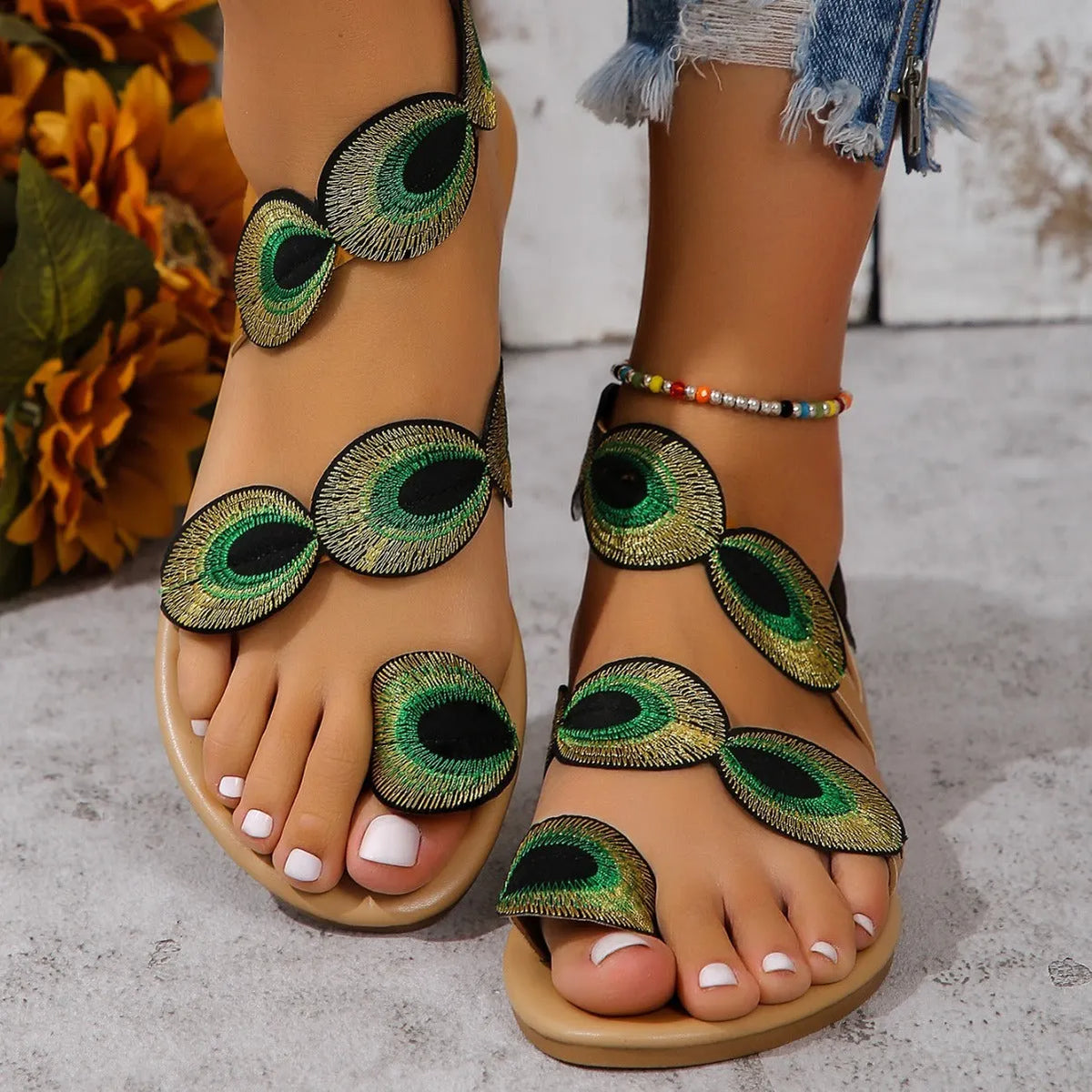 Flat sandal with decorative strap