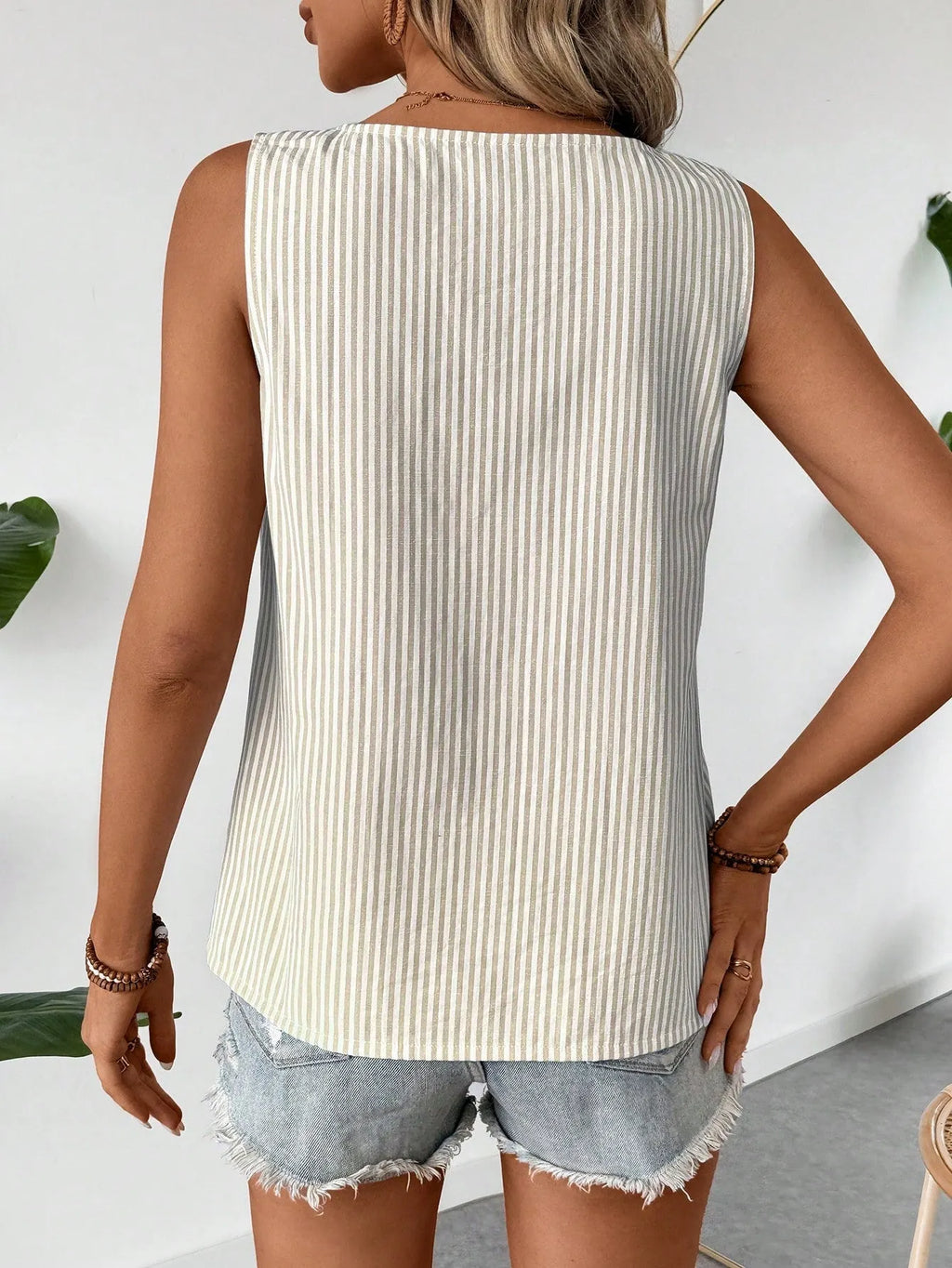 Sleeveless top with diagonal collar